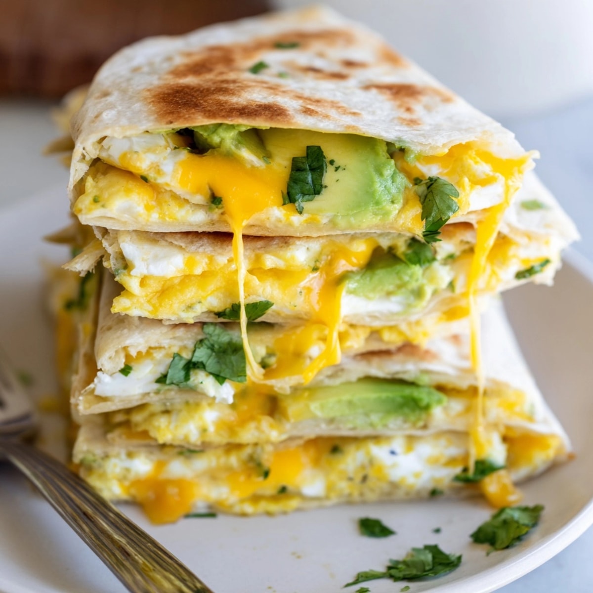 Golden Avocado Egg Cheddar Quesadillas cooking in a pan, melted cheese bubbling, ready to eat.