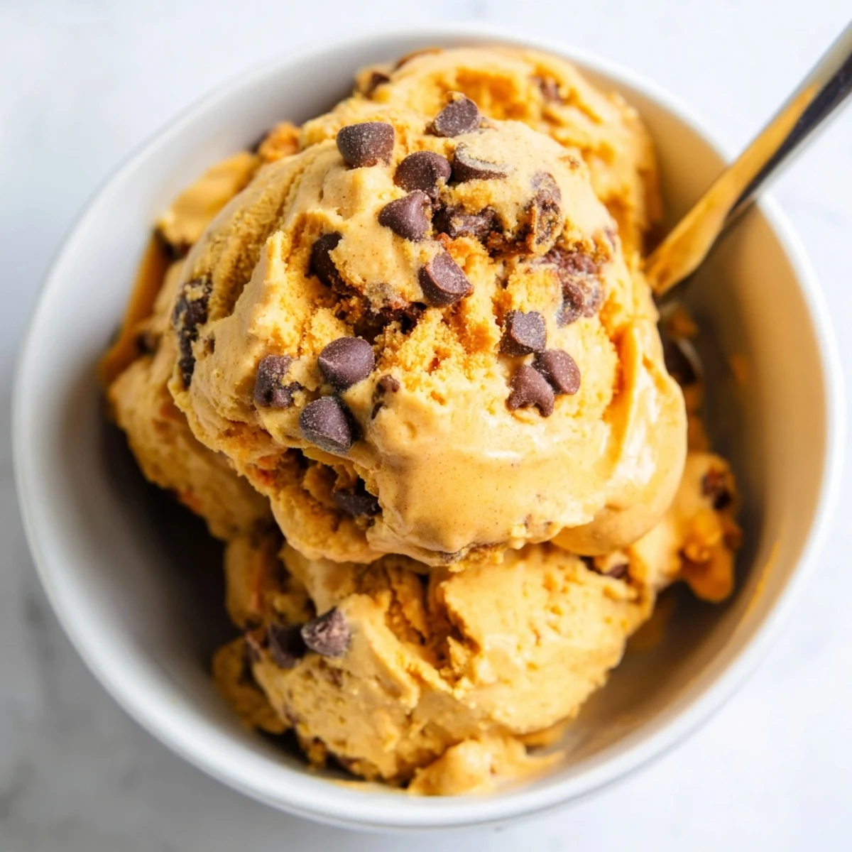 Creamy pumpkin chocolate chip muffin ice cream topped with delicious muffin chunks.  