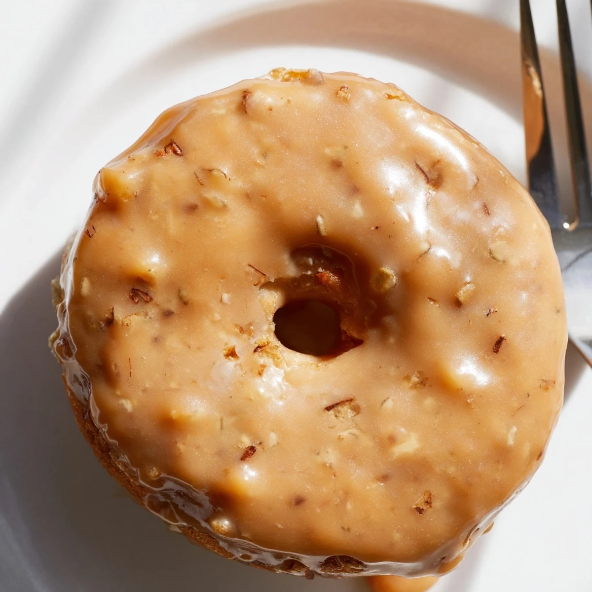 Fluffy Chai Caramel Apple Pancake Donuts drizzled with rich caramel glaze enhance every bite.  