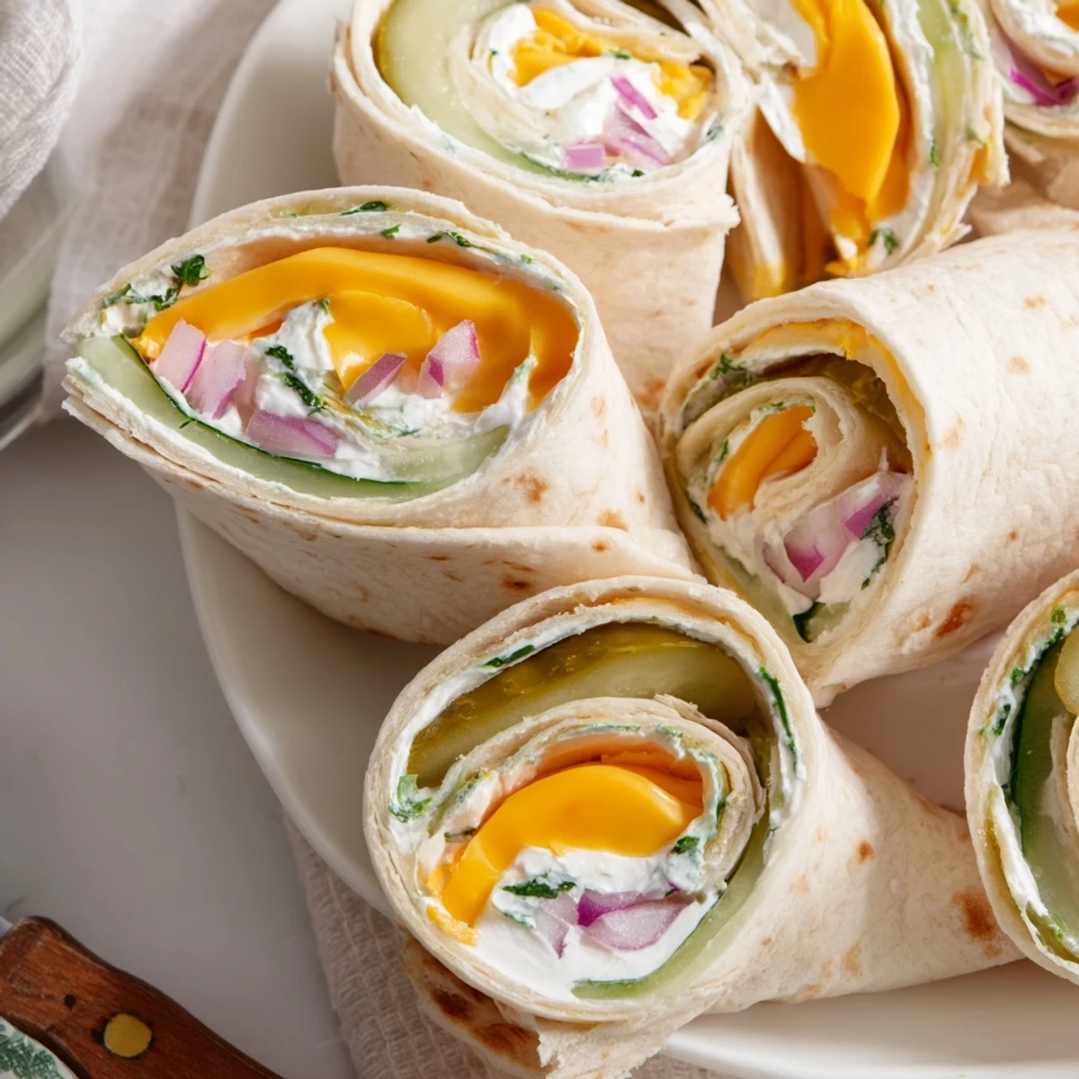 Crispy Pickle-in-a-Blanket snack, wrapped with creamy cheese and soft tortillas.  