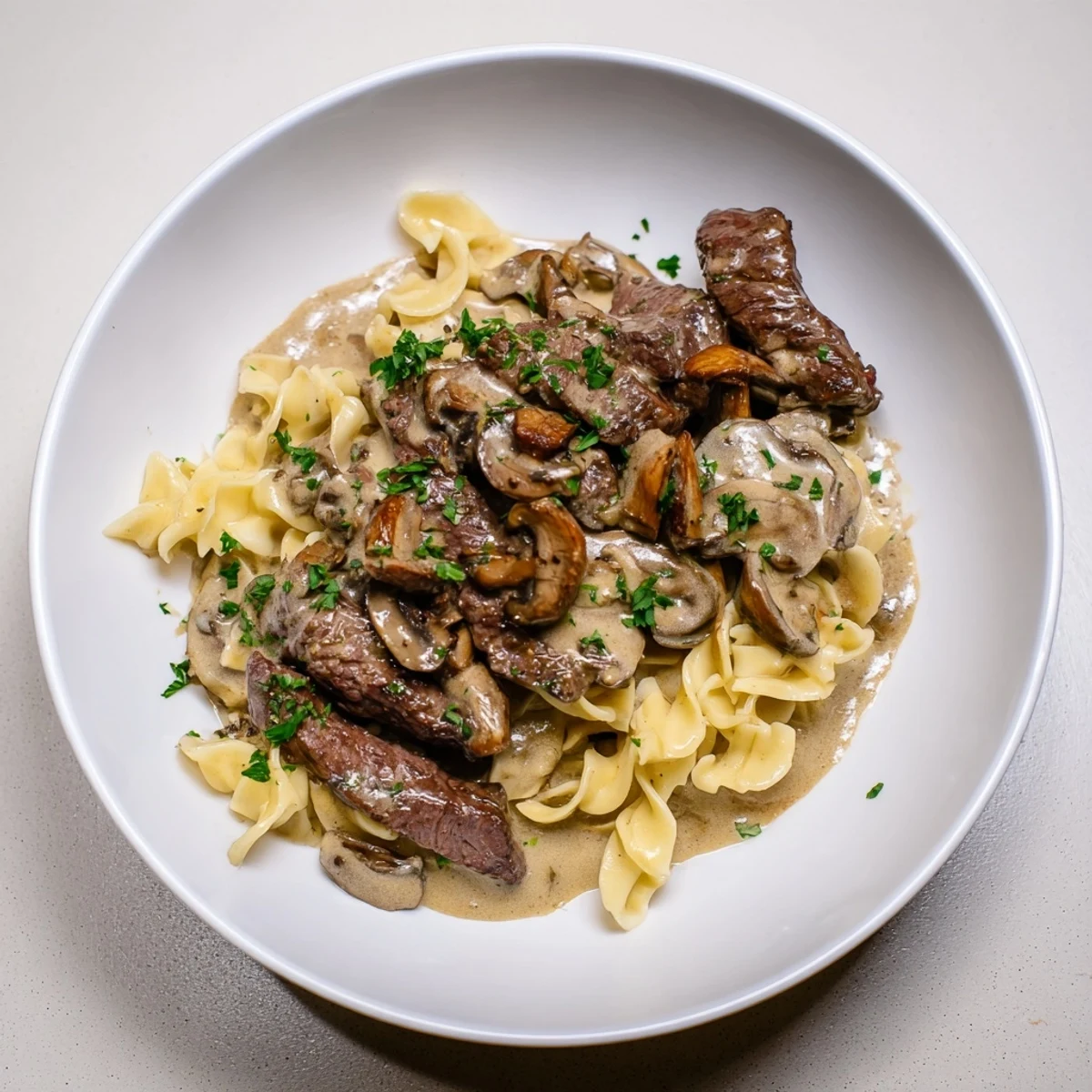 Luscious close-up of Creamy Mushroom Beef Stroganoff, perfect for a cozy weeknight dinner over egg noodles.