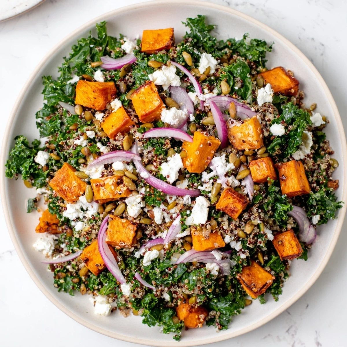 Delicious and colorful Kale & Quinoa Salad, a vegetarian meal with roasted sweet potatoes.