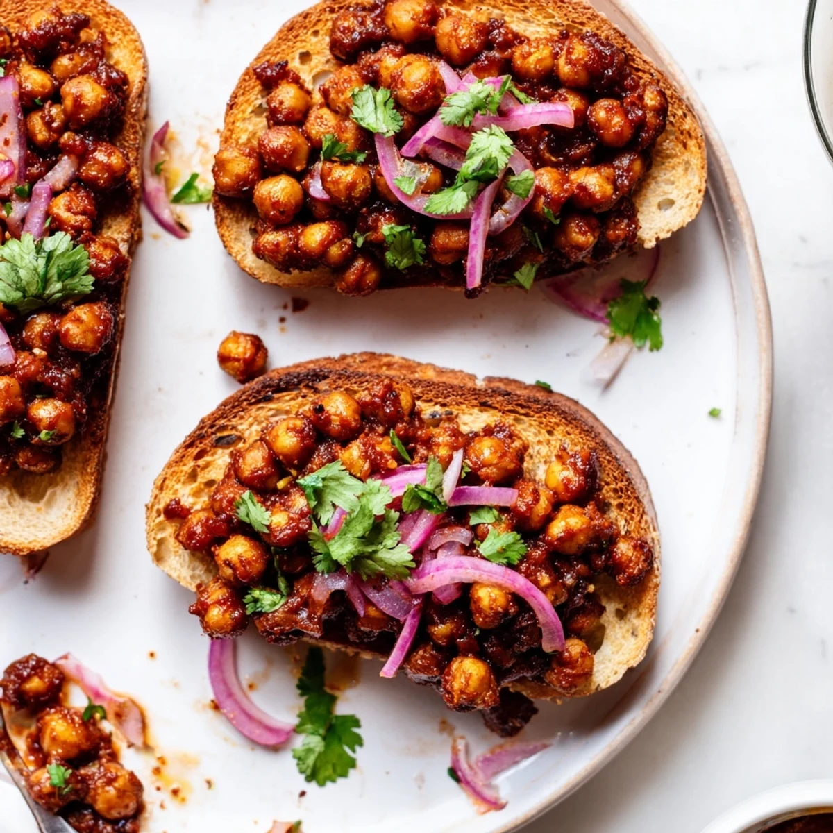 Golden-brown toast piled high with smoky BBQ chickpeas, offering a satisfying vegan lunch.