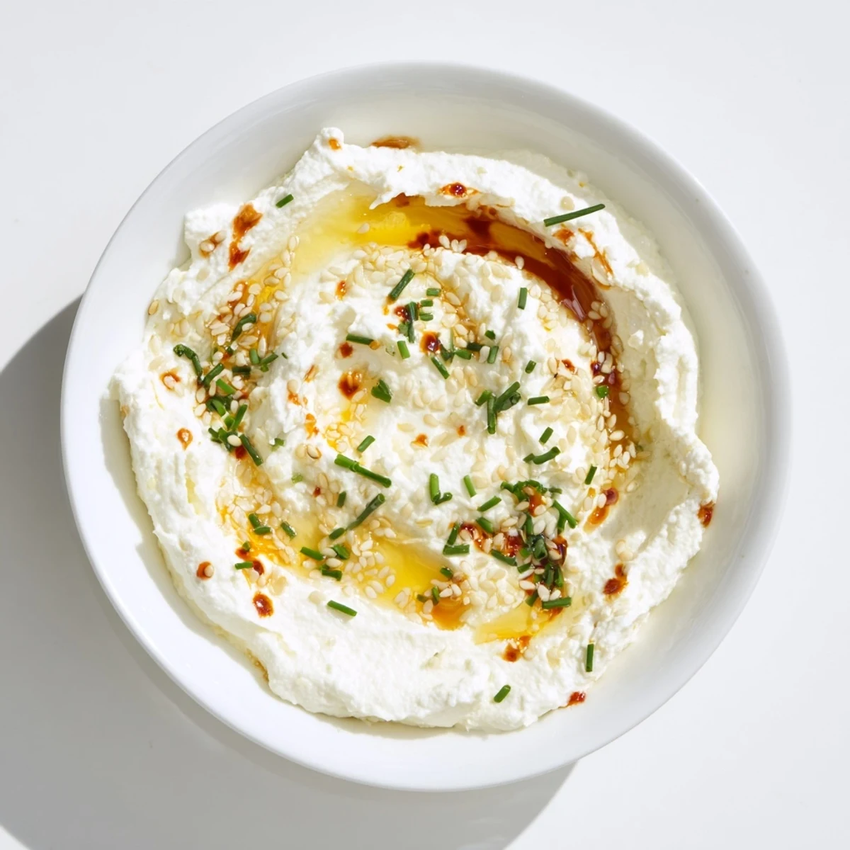 A beautiful close-up of the whipped ricotta dip drizzled with spicy, amber-colored hot honey.