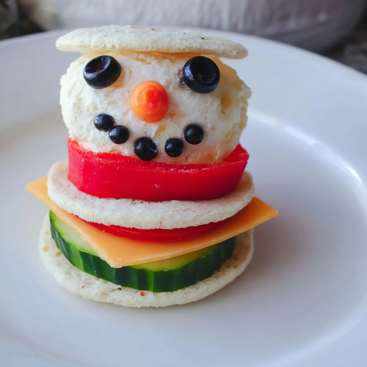 A whimsical Snowman Sandwich Stack, perfect for a festive winter lunch for the family.