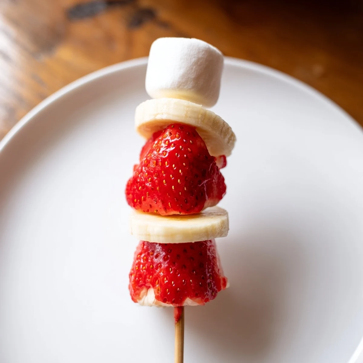 Sweet strawberry banana Santa sticks, perfect for kids, feature ripe bananas and vibrant strawberries.