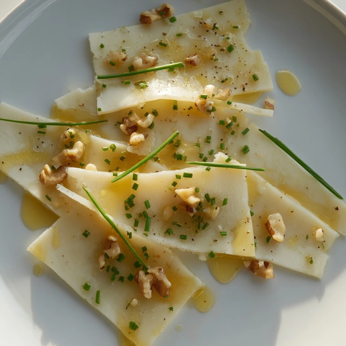 Swiss cheese slices arranged in a fan, ready to eat as a quick appetizer with chives.