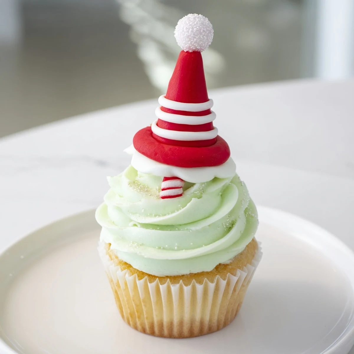 Festive Elf Hat Cupcakes tower high with colorful buttercream and sweet fondant hats.
