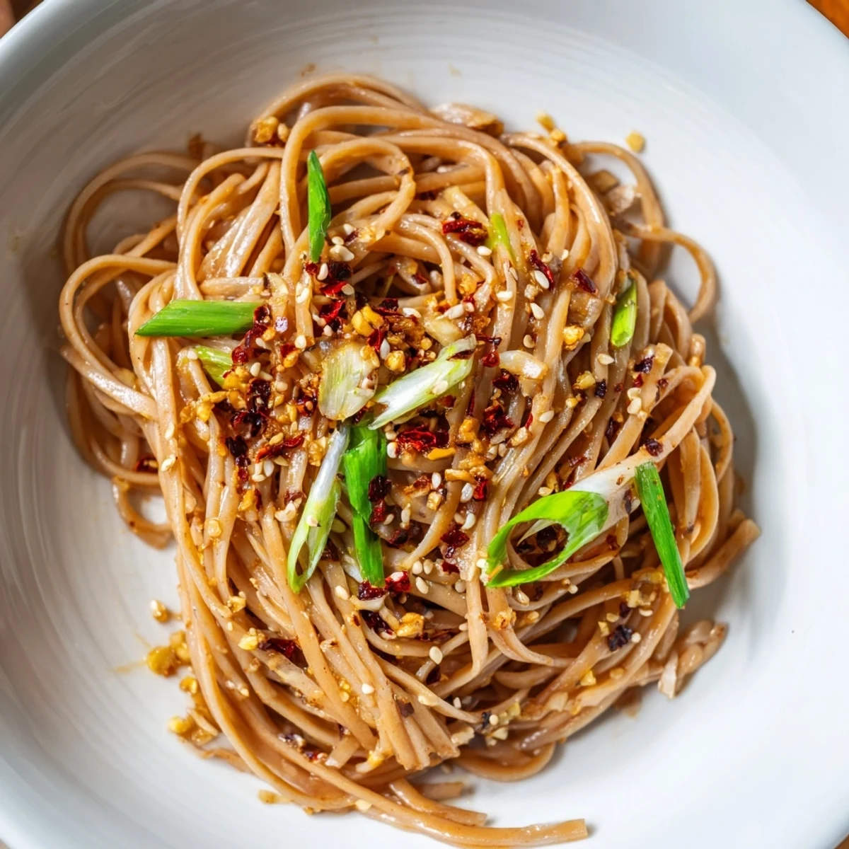 Delicious Garlic Chili Oil Noodles ready to eat, served hot with sesame seeds and fresh ingredients.