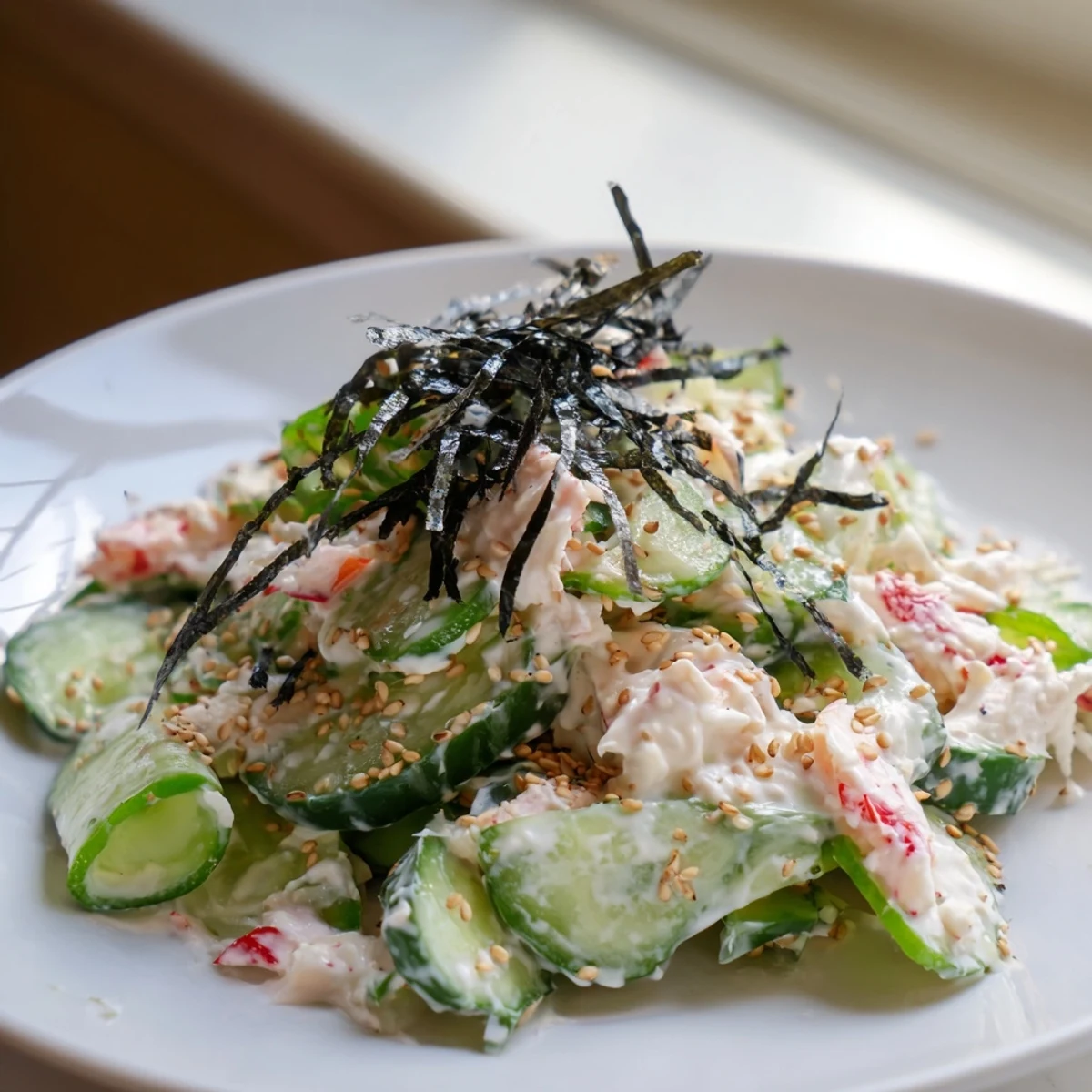 Brightly colored California Roll Cucumber Salad, with visible sesame seeds on top for textural contrast and flavor.