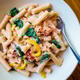 Beautifully plated Lightened-Up Vodka Rosé Christmas Pasta, showcasing the festive red and green colors and flavors.