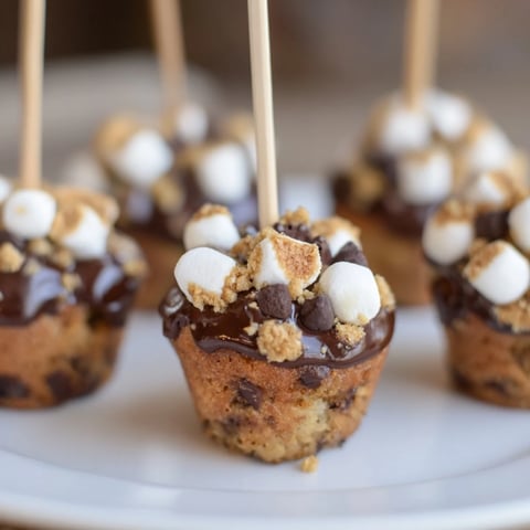 Delicious Smores Cinnamon Sweet Tea Muffin Pops topped with melted chocolate and mini marshmallows.  