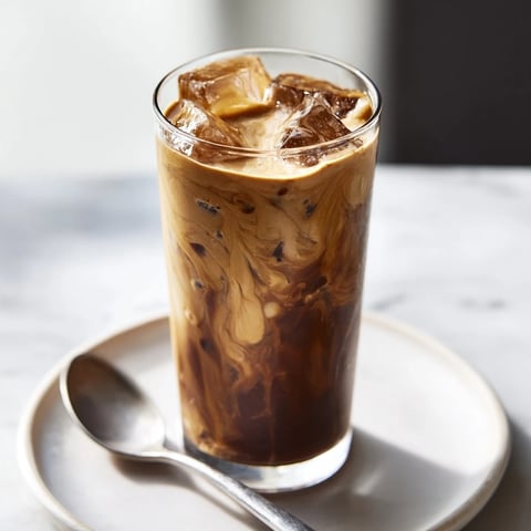 Rich, creamy Tahini Iced Coffee served over ice with a sweet drizzle.  