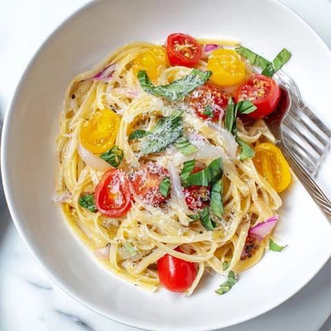 Steaming Cozy Fireplace One-Pan Tomato Basil Pasta with vibrant red tomatoes and fresh basil, ready to eat.