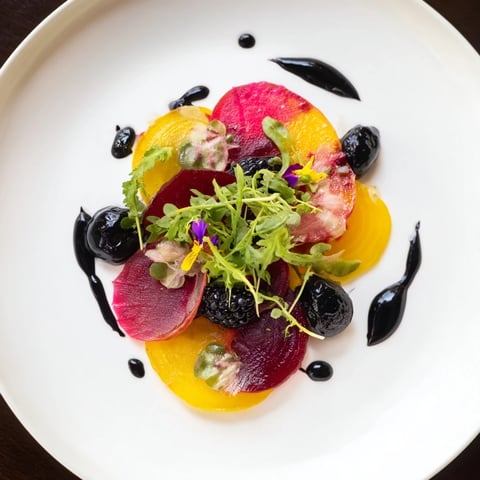 Artful The Shadow Play appetizer: Thin beet slices, rich dark olives, and blackberries create a beautiful contrast.