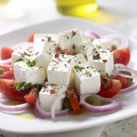 Vibrant Sun-Drenched Patio mezze platter with feta, olives, and fresh vegetables ready to enjoy.