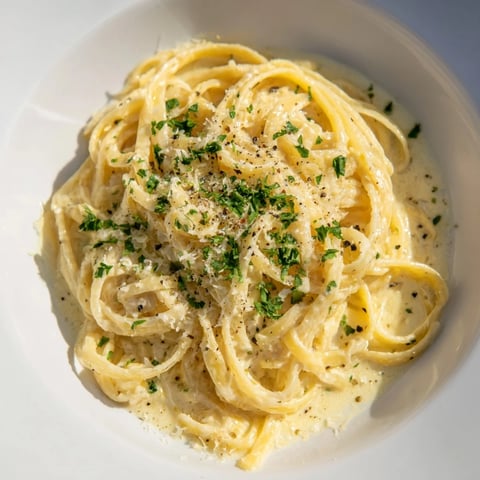 Creamy Lemon-Garlic Greek Yogurt Pasta, ready to eat, topped with fresh parsley and Parmesan.