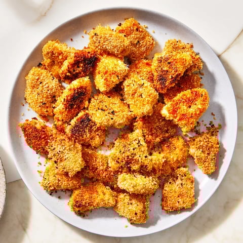 Air fryer un-fried chicken nuggets, perfectly crispy and golden brown, ready for dipping.