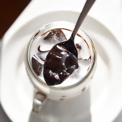 Rich, dark chocolate cracks atop the creamy Chocolate Cracking Iced Latte, a perfect summer drink.