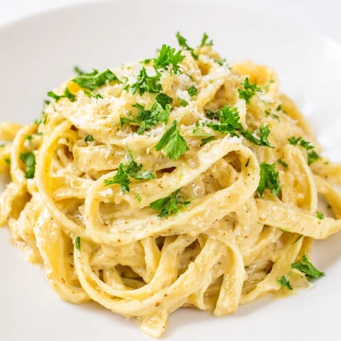 Creamy sriracha honey pasta tossed in a spicy garlic butter sauce, garnished with fresh parsley and parmesan.