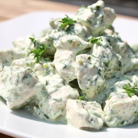 Juicy baked chicken chunks tossed in creamy Green Goddess dressing, served over fresh mixed greens with cherry tomatoes and avocado slices.