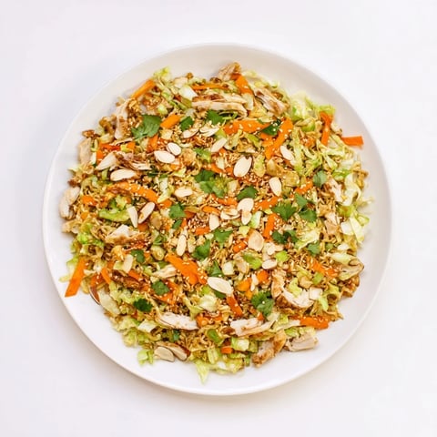 Shredded cabbage, rotisserie chicken, and crushed ramen noodles tossed in a sweet sesame dressing for a quick lunch.