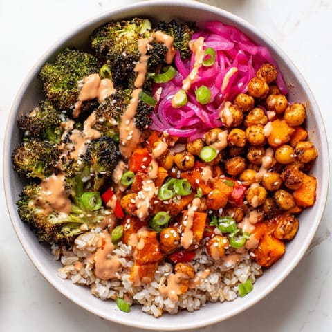 Colorful grain bowls featuring miso-butter sauce with chickpeas and roasted sweet potatoes.  