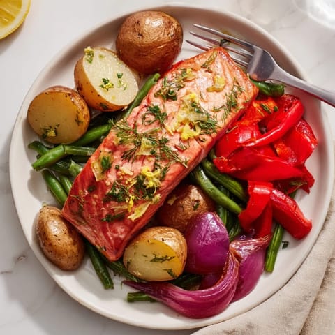 Succulent Lemon Herb Salmon & Potato Sheet Pan with vibrant veggies and golden crispy edges.  