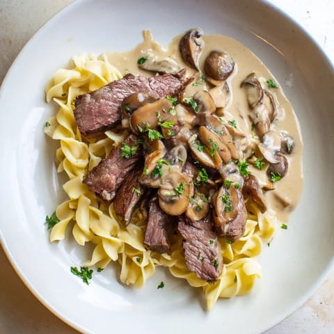 Sizzling beef stroganoff, a comforting Russian classic, featuring savory mushrooms, ready to be served.