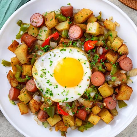 Hearty Egg & Potato Hash incorporating hot dogs, featuring perfectly cooked eggs and crispy potatoes.