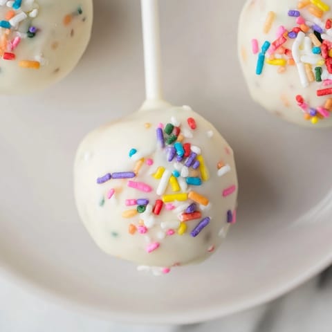 These lightened-up sugar cookie cake pops showcase a mix of textures: soft cake within a sweet shell.