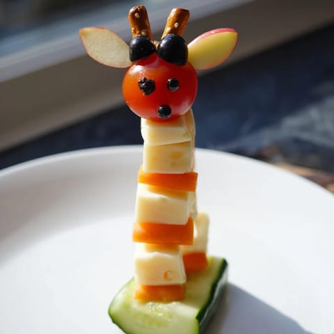 This fun and colorful Long-Necked Giraffe Snack Tower features cheddar and gouda cheese layers topped with a pretzel neck.