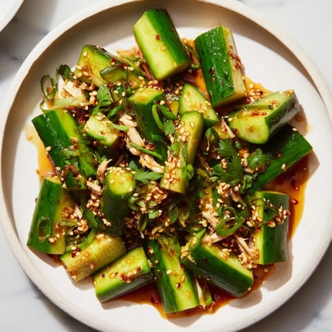 A vibrant close-up of the flavorful Whole Cucumber Logan Salad, ready for a satisfying bite.