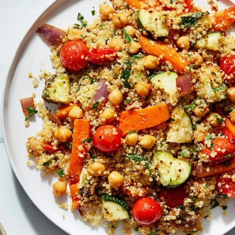 Vibrant Quinoa Power Salad: chickpeas, tomatoes, and parsley with a creamy tahini-lemon dressing.