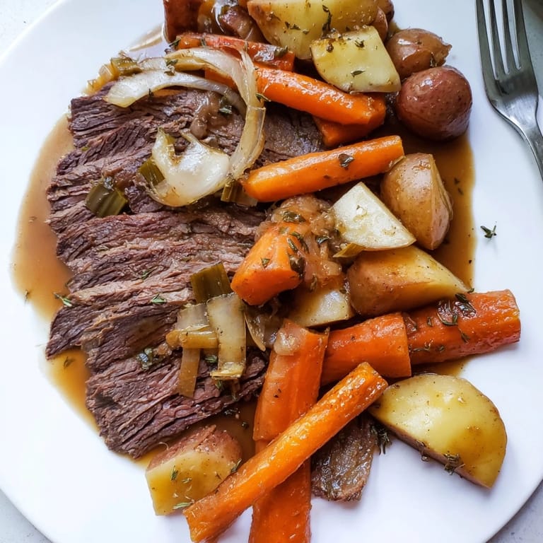 A succulent Sunday pot roast simmered impeccably with vibrant, juicy vegetables.  