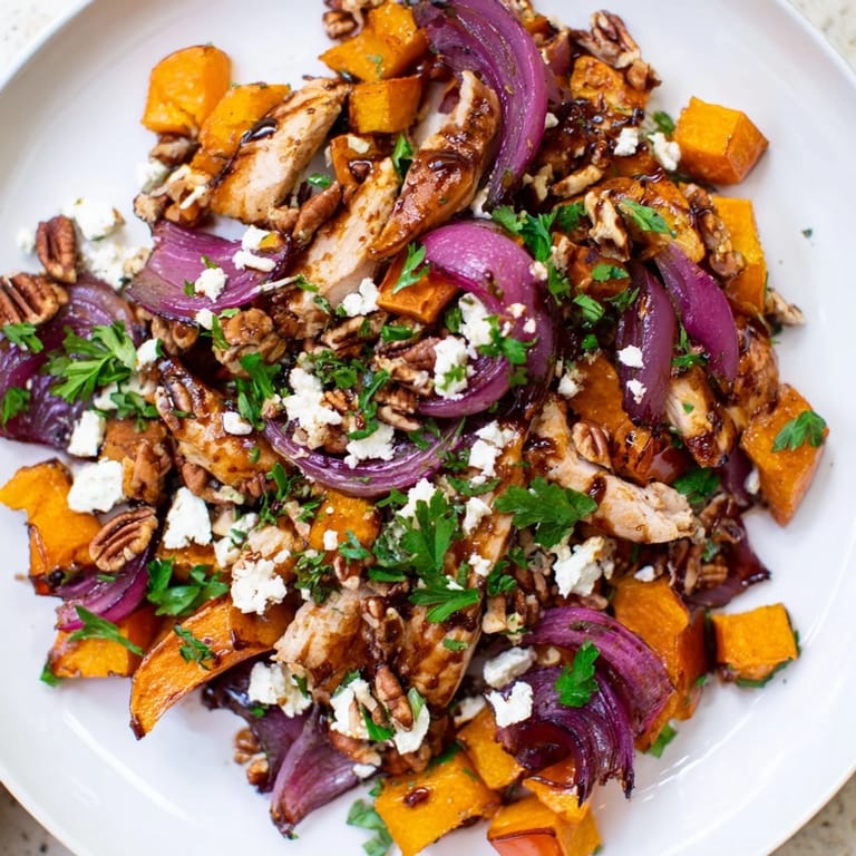 Enjoy a warm bowl of flavorful Roasted Chicken & Winter Squash Sheet-Pan Salad, featuring caramelized squash and hearty chicken.