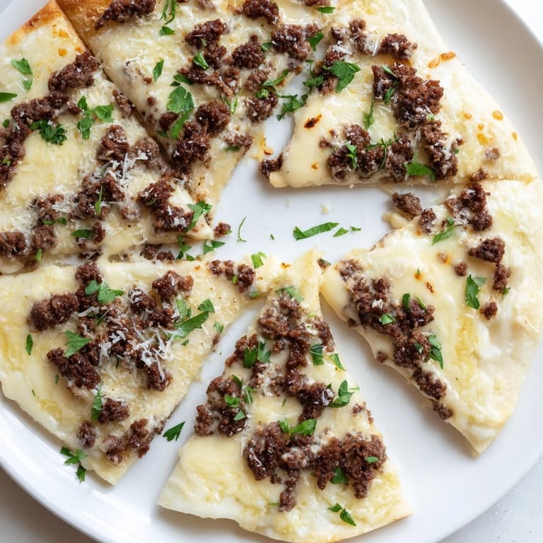 This Ground Beef Alfredo Pizza offers a taste of Italian comfort food, brimming with melted cheese.